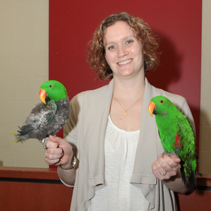 smiling woman holding two birds