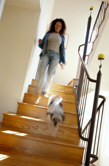 woman walking downstairs with dog